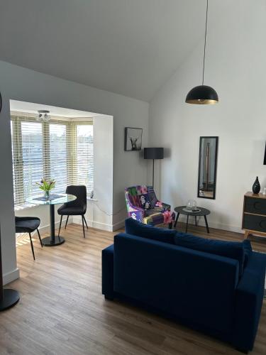 a living room with a couch and a table at Blundens Holiday Lets - Kellingley in Chichester