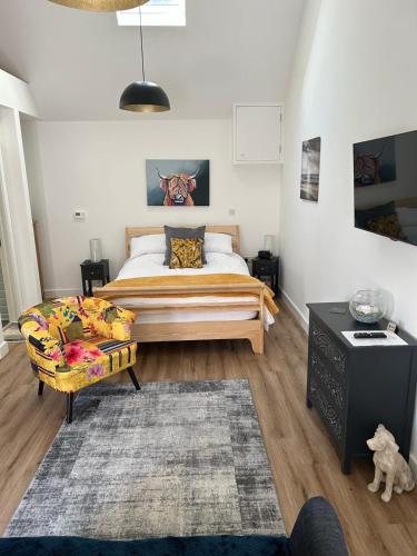 a bedroom with a bed and a couch at Blundens Holiday Lets - Ffos Las in Chichester