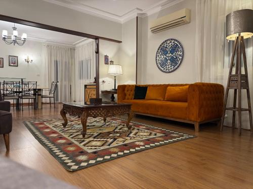 a living room with a couch and a table at Nile View Apartment in Zamalek Stays in Cairo