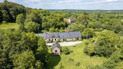 an aerial view of a large house in the forest at FORET TOTEM - Hébergements nature et bien-être en pleine forêt in Persquen