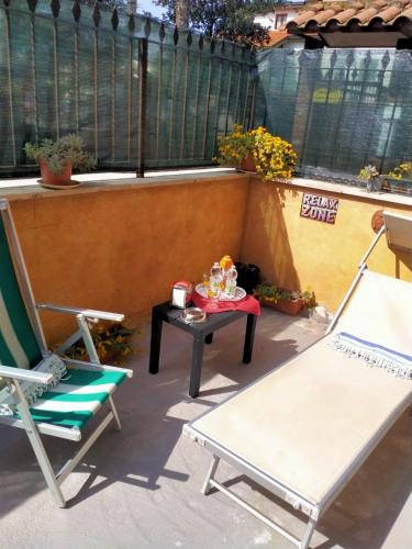 a small patio with two chairs and a table at Terry Road House in Monterotondo