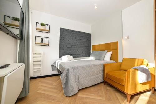 a bedroom with a bed and a chair at Homly Nook in Rīga