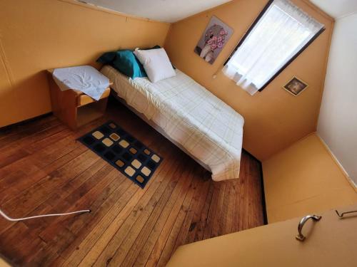 an overhead view of a bedroom with a bed and a window at CasaNancy in Panguipulli