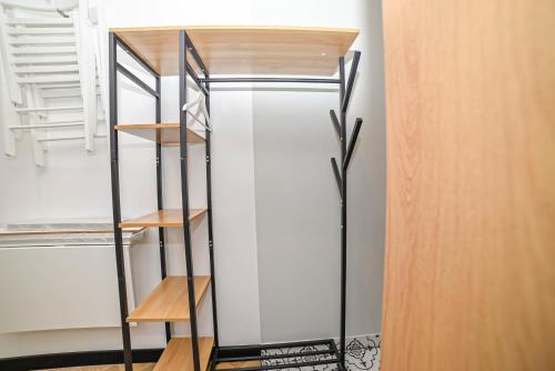 a glass bookcase in a room with a shelf at Homly Nook in Rīga