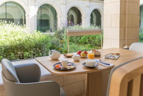 a table with a tray of food on it at Fontevraud L'Ermitage in Fontevraud-l'Abbaye