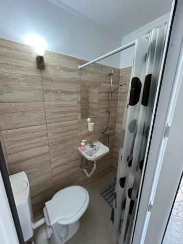 a small bathroom with a toilet and a sink at Casa Haralambie in Greci