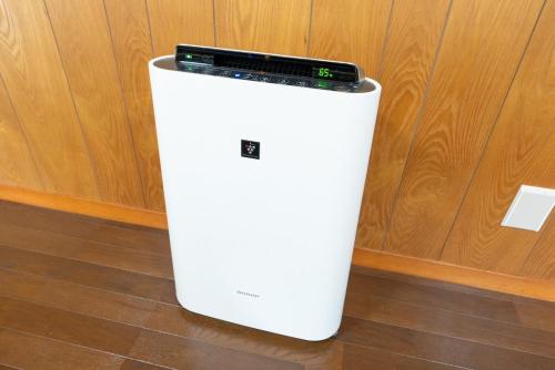 a white refrigerator with a phone on top of it at Green Oasis Cottage A in Hakone