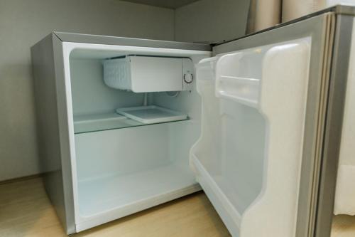 an empty refrigerator with its door open in a kitchen at Sea Side at Ao Nang Landmark Night Market Krabi in Ban Khlong Haeng