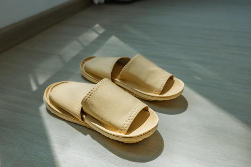 a pair of tan shoes sitting on a floor at Sea Side at Ao Nang Landmark Night Market Krabi in Ban Khlong Haeng