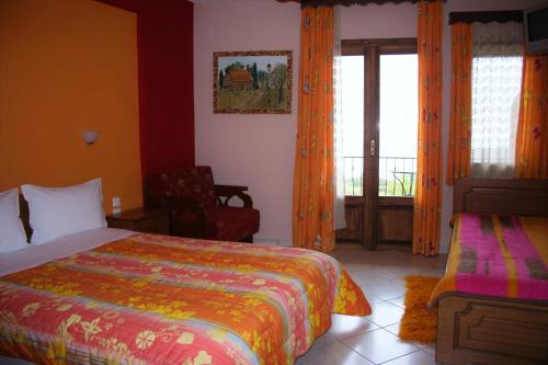 a bedroom with a bed and a window with a balcony at Guesthouse Mitsiopoulou in Neochori
