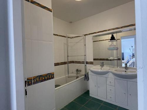 a white bathroom with a sink and a shower at Maison charmante près du lac d'Esparron, 2 chambres, parking - FR-1-822-10 in Esparron-de-Verdon