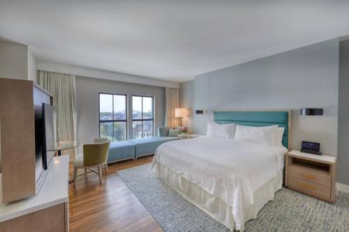 a hotel room with a bed and a flat screen tv at Hotel Effie Sandestin Resort, Autograph Collection in Destin