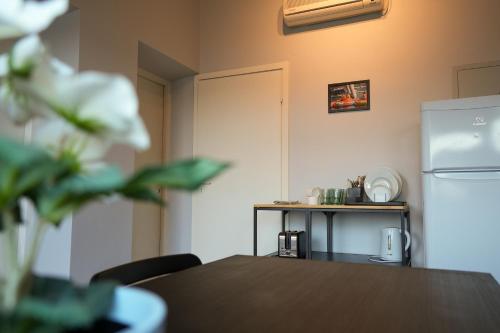 a kitchen with a table and a refrigerator at 6 vietų namelis ant ežero kranto in Sudervė