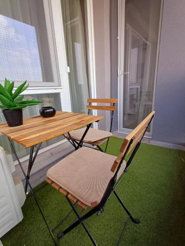 a table and chairs in a room with a window at Your Home in Plovdiv with Free Private Parking in Plovdiv