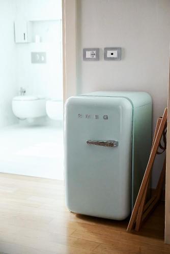 a green suitcase sitting on the floor in a room at Hotel Belvedere Ranco in Ranco