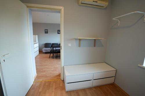 a room with a white closet with a table at 6 vietų namelis ant ežero kranto in Sudervė