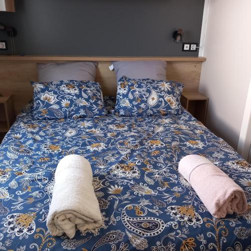 un lit avec deux serviettes et des oreillers dessus dans l'établissement Mobil home tout équipé, Camping 4 Etoiles, plage à 100m, à Canet