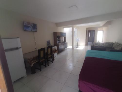 a large room with a bed and a couch at Casa praia in Pelotas