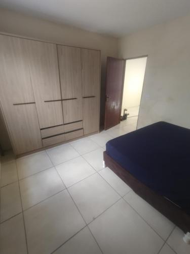 a bedroom with a bed and wooden cabinets at Casa praia in Pelotas