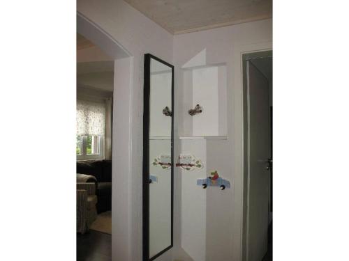 a mirror on a wall next to a living room at Ferienwohnung am Brunnen in Titisee-Neustadt