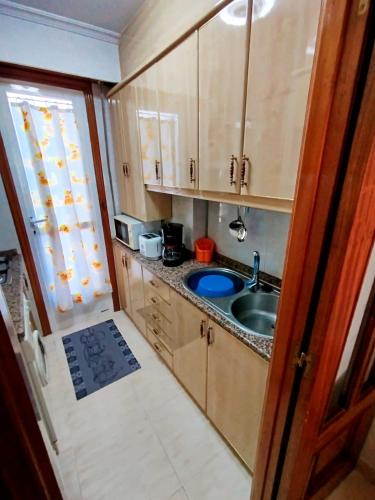 a small kitchen with a sink and a window at Vivienda Maceda in Maceda