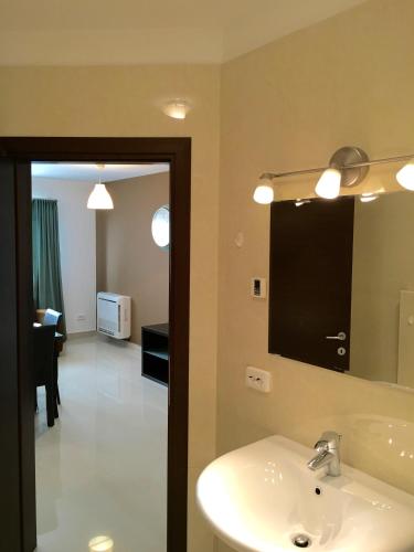 a bathroom with a sink and a mirror at Elysium in Bucharest