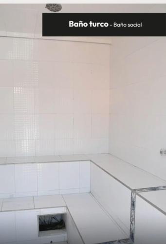 a white tiled wall in a bathroom with a sink at finca en ginebra el eden in Ginebra
