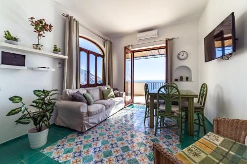 a living room with a couch and a table at Villa Panorama in Positano