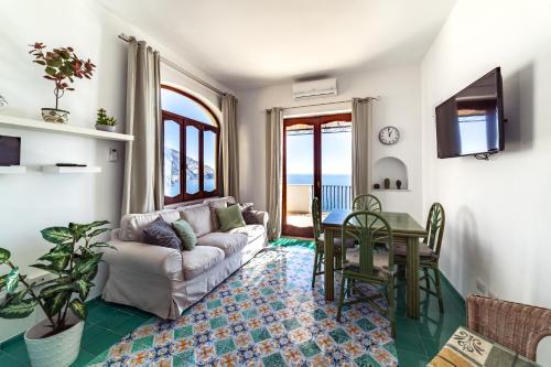 a living room with a couch and a table at Villa Panorama in Positano