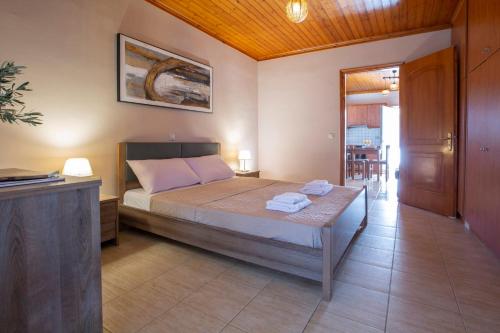 a bedroom with a bed with two towels on it at Lemon House Lefkada in Lefkada