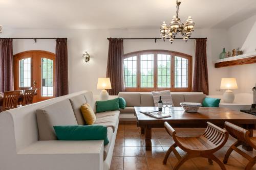 a living room with a couch and a table at New! Villa Can Bassetes in Can Furnet