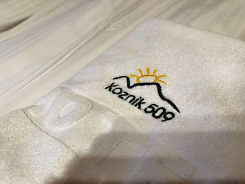 a white napkin with the name of a sun on it at Konaci Kopaonik 28 in Kopaonik