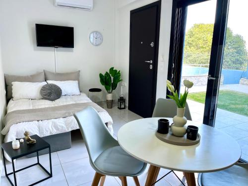 a bedroom with a bed and a table and chairs at Blue dream in Nikiana