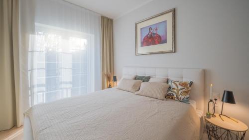 En eller flere senge i et værelse på Apartmán Donizetti D 10