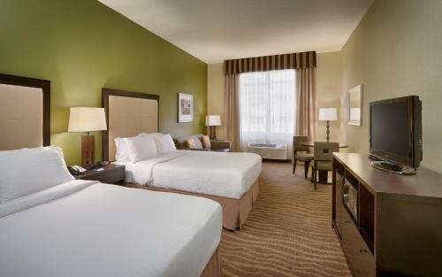 a hotel room with two beds and a flat screen tv at Holiday Inn Express & Suites American Fork - North Provo by IHG in American Fork