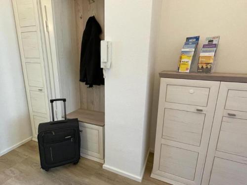 a suitcase is sitting in a room with a door at Ferienhaus Jäger in Friedrichshafen