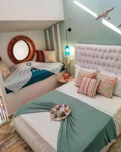 a bedroom with two beds and a mirror at Aelia House Chalkidiki in Fourka