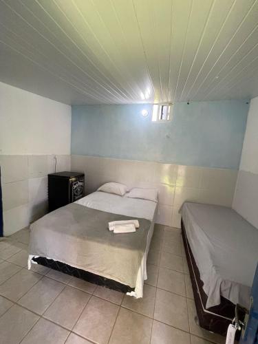 a bedroom with two beds in a room at Pousada Bê kite cauipe in Caucaia