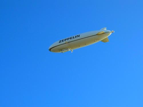 an airplane flying in the blue sky at Ferienhaus Jäger in Friedrichshafen