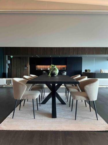 a dining room with a black table and chairs at Ocean View Suite in Ytri-Njarðvík