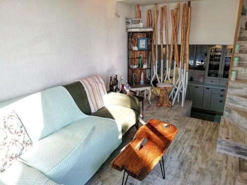 a living room with a couch and a table at Aelia House Chalkidiki in Fourka