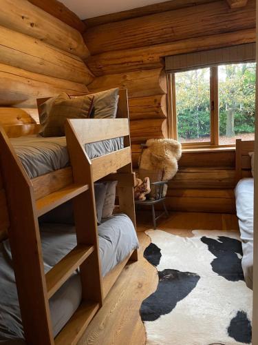 a bedroom with bunk beds in a log cabin at Fir Lodge in Kings Lynn