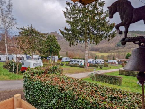 a statue of a horse on a bell in a park at Nideggener Burgwagen 1016 in Nideggen