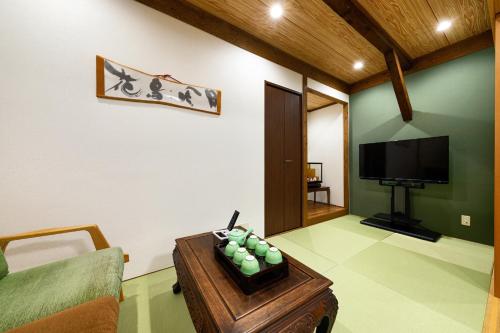 a living room with a couch and a tv at 青羽-観蔵 in Osaka