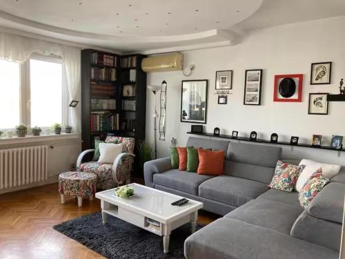 a living room with a couch and a coffee table at Recently renovated room with Danube view in Novi Sad