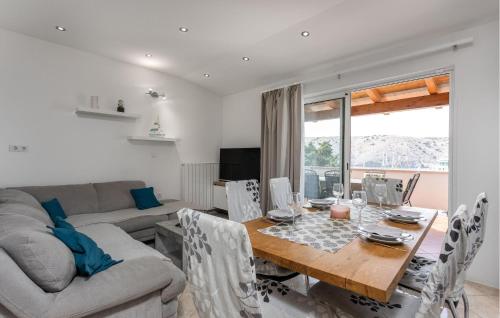 a living room with a table and a couch at 2 Bedroom Beautiful Apartment In Lopar in Lopar