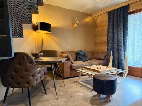 un salon avec un canapé et une table dans l'établissement Micro-lodge, Lune Au Bois, à Montriond