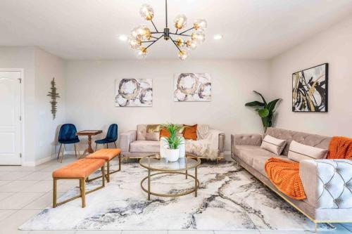 Designer Decorated - 3 Bedroom NEAR DISNEY في كيسيمي: غرفة معيشة بها أريكة وطاولة