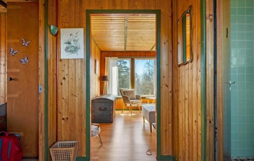 a hallway leading to a living room with wooden walls at 2 Bedroom Stunning Home In Vordingborg in Vordingborg