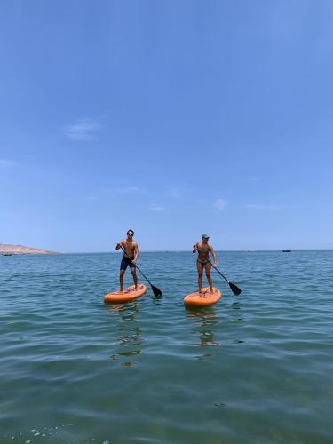 two people on paddle boards in the water at Condominio Náutico SOTAVENTO - PARACAS in Paracas